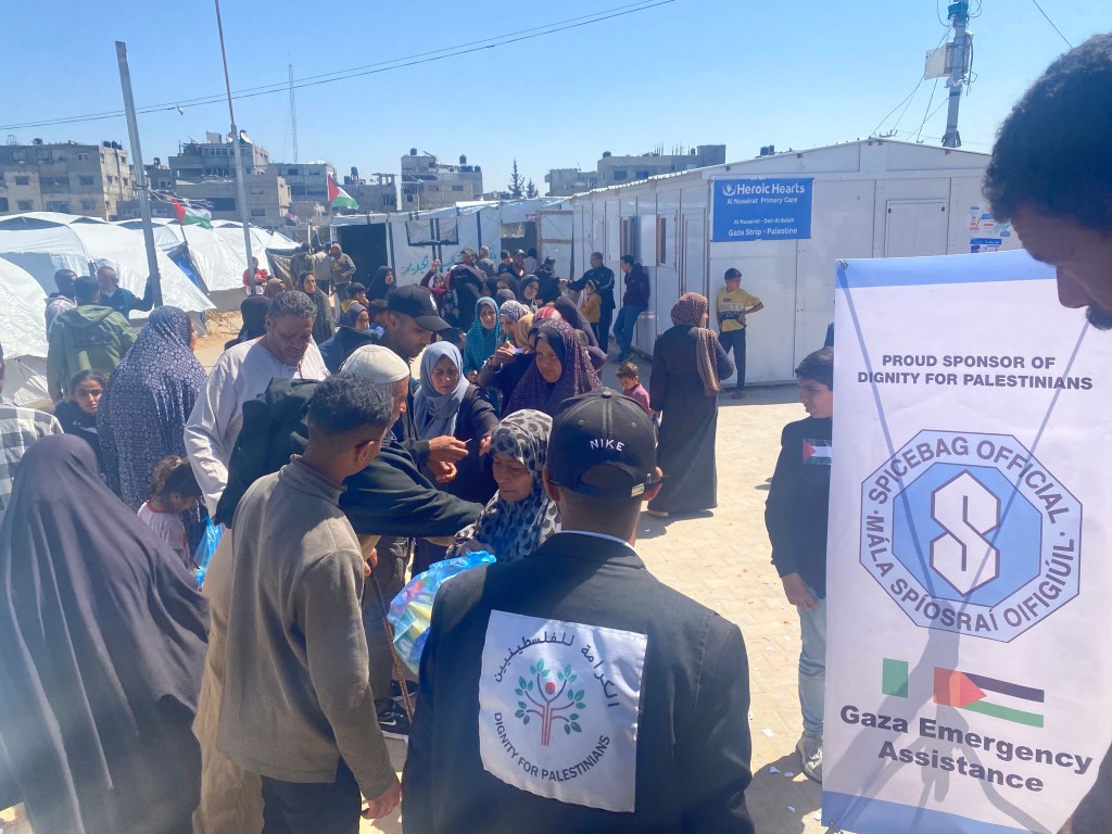 Palestinian women in line to collect emergency relief parcels.